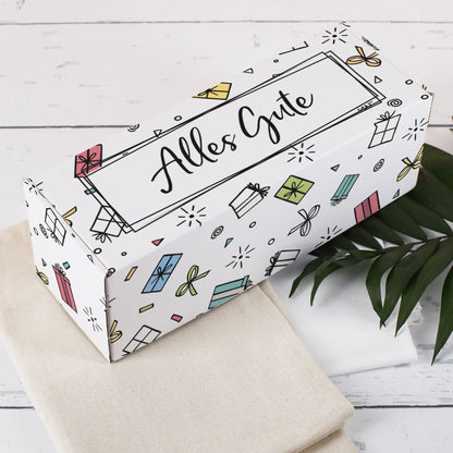 Geschenkverpackung mit „Alles Gute“-Motiv – Deckelansicht mit bunten Geschenkpaketen auf weißem Hintergrund