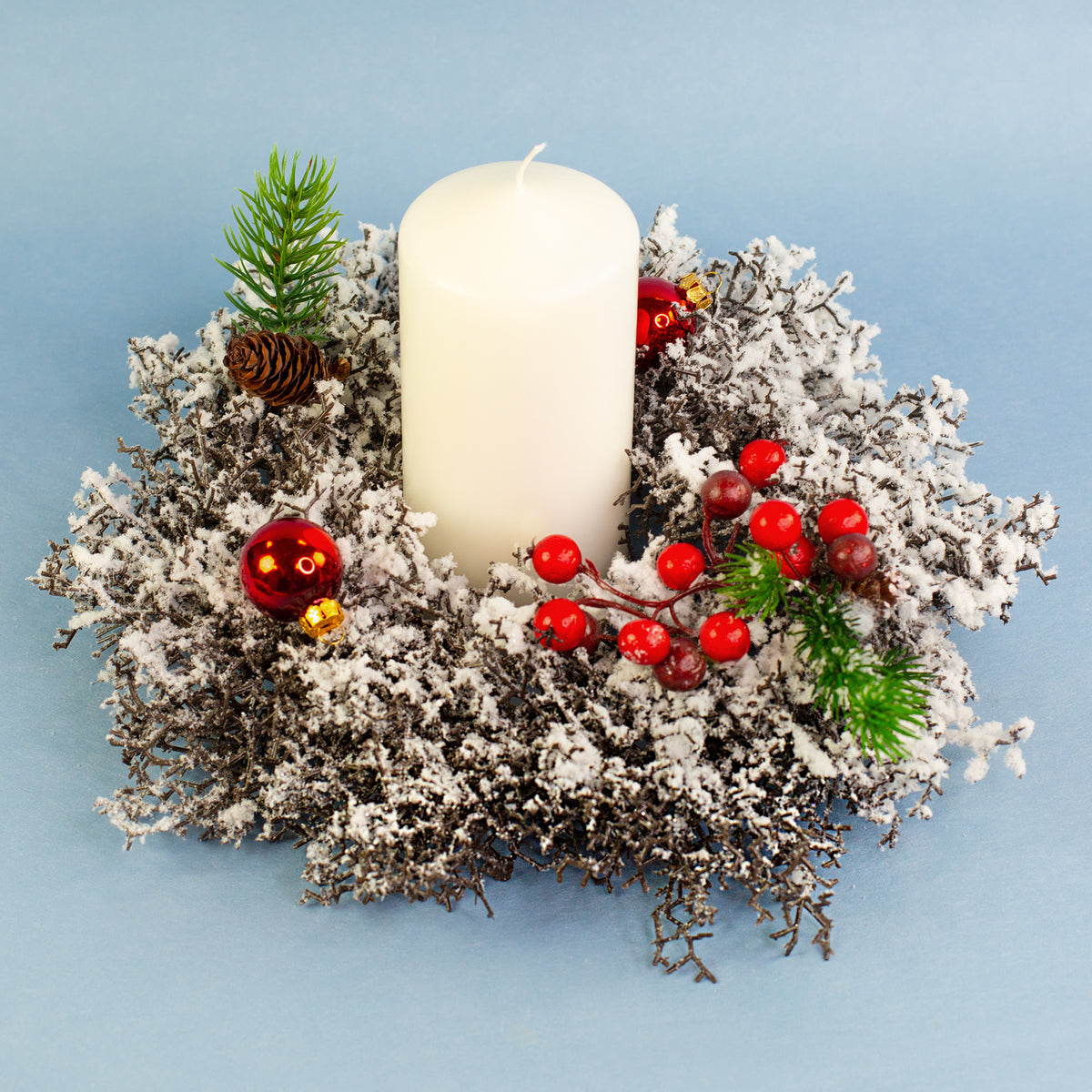 Künstlicher Adventskranz mit roten Beeren und Kugeln als weihnachtliche Tischdeko