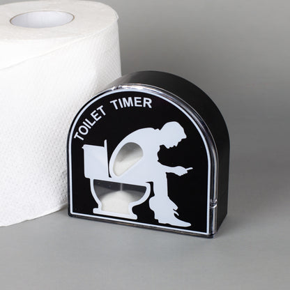 Lustiger Toilet Timer als Sanduhr mit schwarzem Design neben einer Toilettenpapierrolle