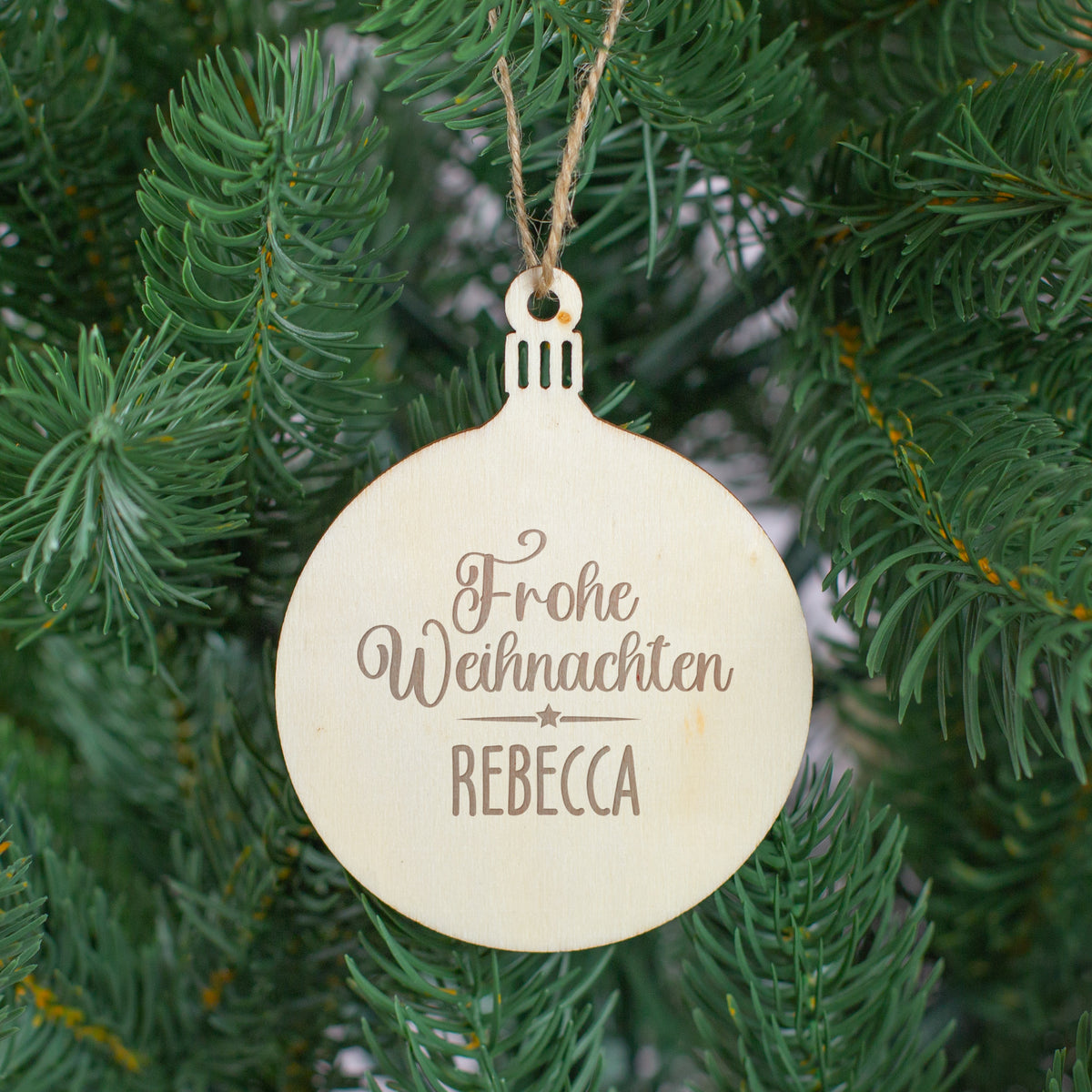 Runder Holzanhänger als Christbaumschmuck mit Gravur „Frohe Weihnachten Rebecca“ – personalisierter Weihnachtsanhänger.