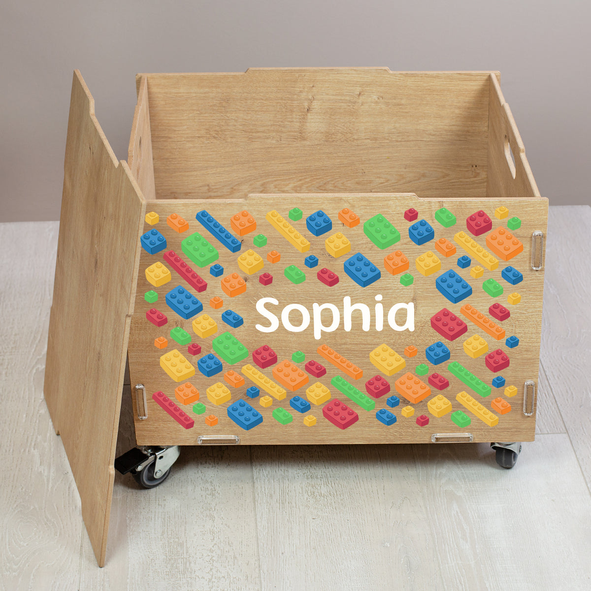 Geöffnete Rollbox aus Holz mit Bausteinwelt-Design und personalisiertem Namen, viel Stauraum für Spielzeug und Bausteine sichtbar