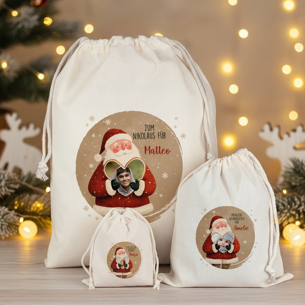 Set aus drei Geschenksäcken mit Weihnachtsmann-Motiv, Foto im Herz und personalisiertem Text – Größen S, M und L gemeinsam auf Holztisch vor weihnachtlicher Beleuchtung.