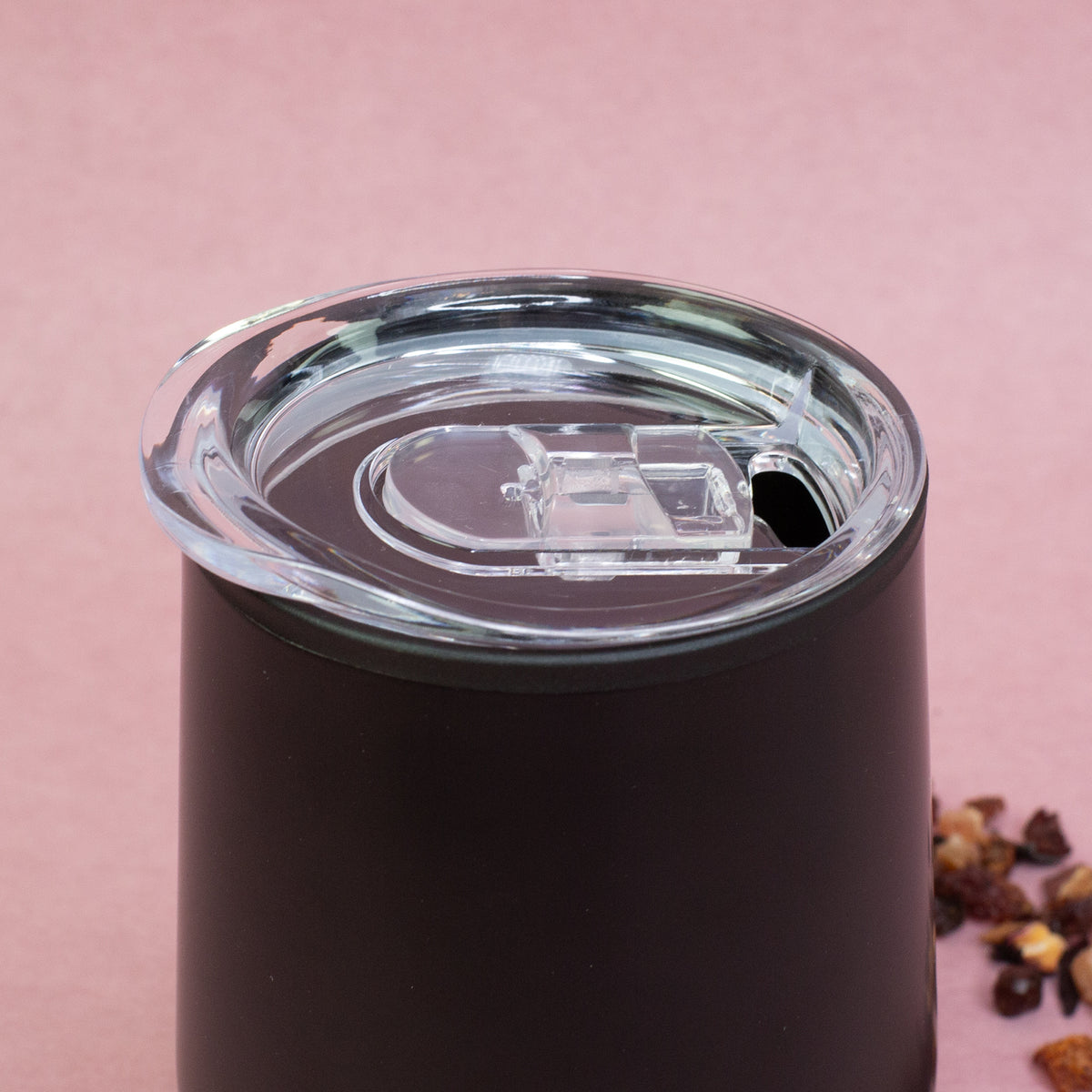 Detailaufnahme des schwarzen Thermobechers mit transparentem Deckel und Schiebeverschluss