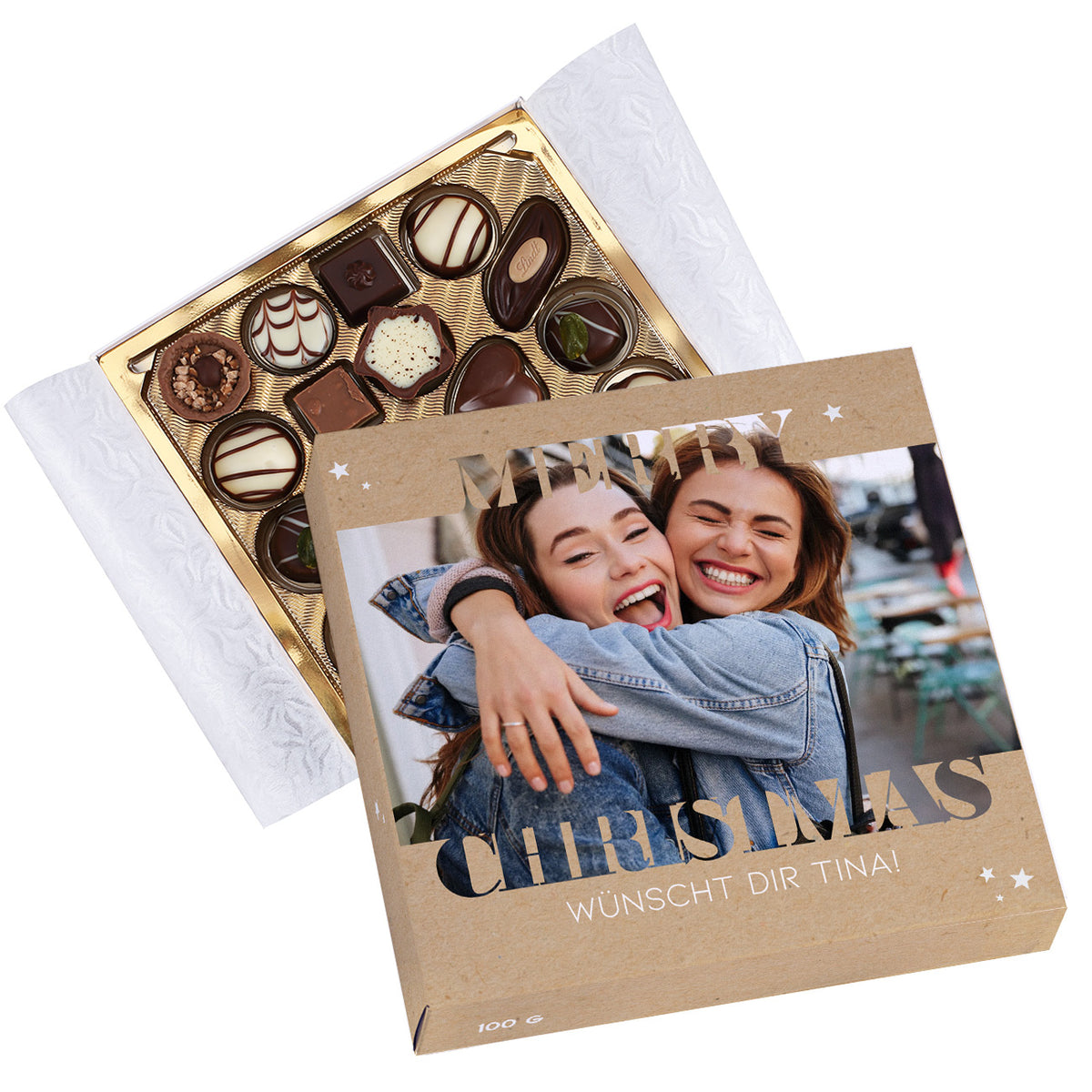 Geöffnete Lindt Pralinenbox Merry Christmas mit goldener Innenschale und personalisiertem Deckel.