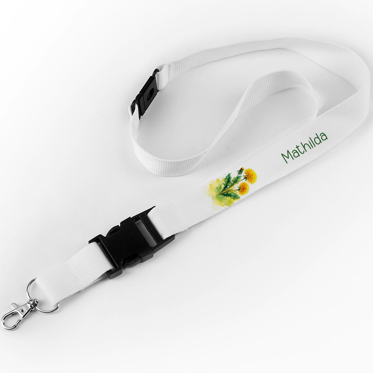Schlüsselband mit dem Namen "Mathilda" und gelbem Löwenzahn-Design auf weißem Hintergrund